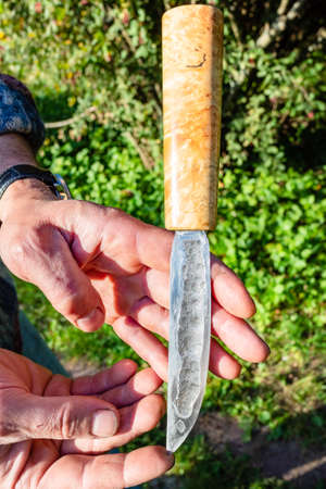 hand forged traditional Siberian steel knife with wooden handle made of Poplar tree burlの写真素材