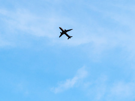 bottom view of airplane in blue evening sky