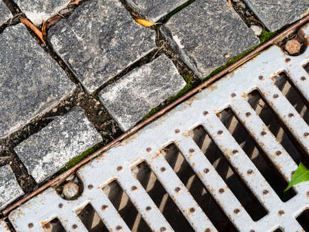 top view of stone paving and old street drain grate in Moscow cityの写真素材