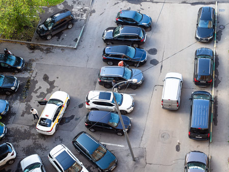 MOSCOW, RUSSIA - SEPTEMBER 19, 2020: top view of cars in outdoor local parking lot in urban...