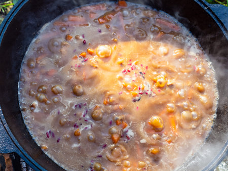 top view of boiling pottage in iron cauldron outdoors