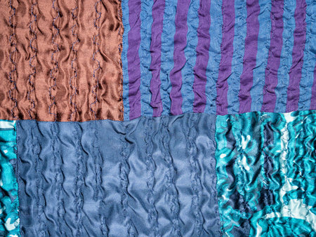 textile background - hand-crafted detail of blue patchwork fabric