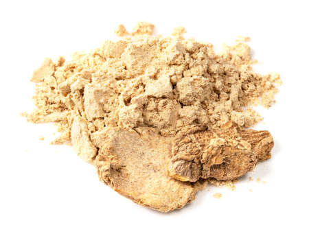handful of dried ginger roots and powder closeup on white backgroundの写真素材