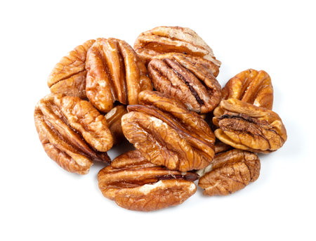 heap of shelled pecan nuts closeup on white background