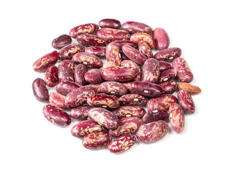 handful of red spotted pinto beans closeup on white background