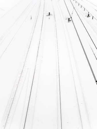 top view of snowy railways at station after snowfall on winter day