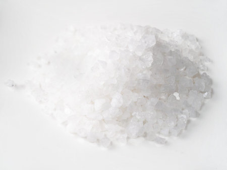handful of coarse sea salt closeup on white plate