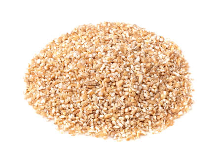 handful of raw Poltavskaya wheat groats (crushed partly hulled wheat grains) closeup on white backgroundの写真素材