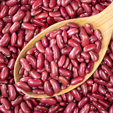 top view of red kidney bean in wooden spoon closeup