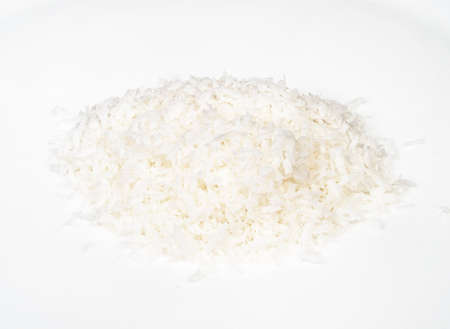 handful of coconut flakes closeup on white backgroundの写真素材