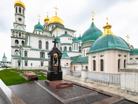 Istra, Moscow Region, Russia - May 6, 2021: tombstone and churchyard near church of Saints Constantine and Helena near cathedral of New Jerusalem Monastery in rain. The monastery was founded in 1656のeditorial素材