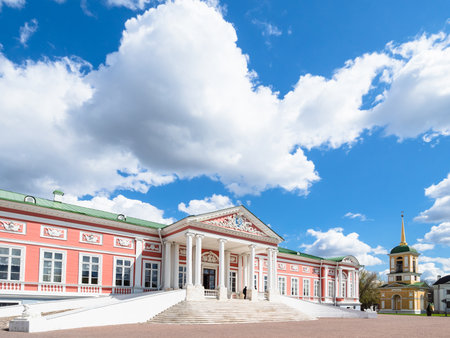Moscow, Russia - May 7, 2021: white cloud over The Palace, Belltower in Kuskovo estate on sunny day. Kuskovo was summer country house and estate of Sheremetev family, it was built in the 18th centuryのeditorial素材