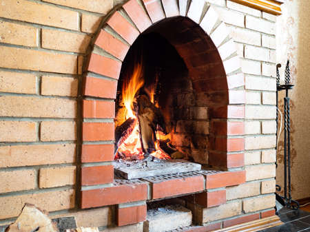 brick fireplace with mantelpiece in country house on cold dayの写真素材