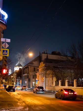Moscow, Russia - December 9, 2021: cars on Prechistenka street illuminated with yellow urban lights between Ostozhenka and Arbat streets in center of Moscow city after snow in winterのeditorial素材