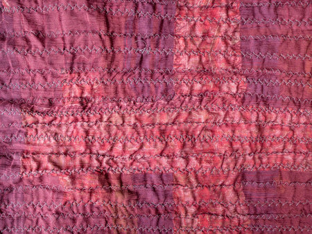 stitched back side of handcrafted crinkled red silk scarf close up