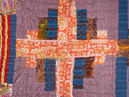 detail of handcrafted crinkled silk patchwork scarf with geometric pattern close up