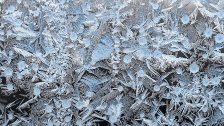 panoramic natural frost pattern on window glass closeup on cold winter day