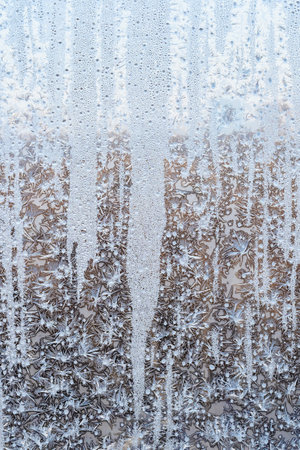 iced home window glass on cold winter dayの写真素材