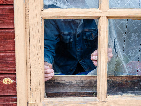 installation of window pane in rural house close up