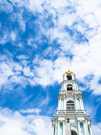 belfry of orthodox church under white clouds in blue skyの写真素材