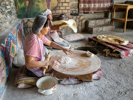 Goght, Armenia - August 25, 2023: master class on making lavash in traditional Armenian rustic bakery. Lavash is thin flatbread baked in tandoor (tonir or tanoor) and common to South Caucasus cuisinesのeditorial素材