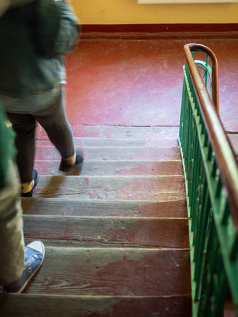 people go down the old steps in entrance of residential building in Kaliningrad city, Russia