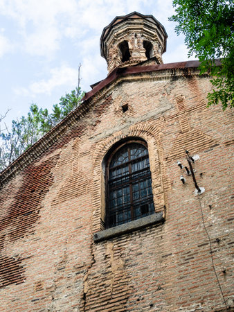 wall of old Saint George of Mughni Church in Tbilisi city on summer day, Georgiaの写真素材