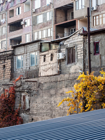 facade of old apartment house in Yerevan city on sunny autumn evening twilightの写真素材