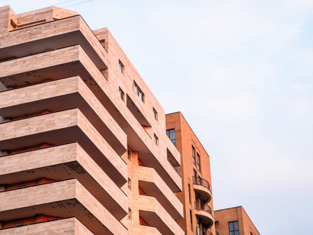 pink high-rise apartment building in Yerevan city in winter evening twilight