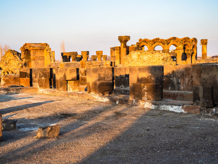 ruined medieval Armenian Zvartnots Cathedral illuminated by setting sun on sunny winter eveningの写真素材