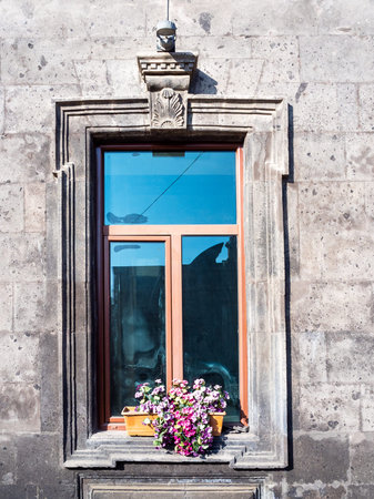 window with flower pot on facade of black tuff house in Kumayri Historical and Cultural...