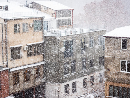 snowfall over residential houses on winter day in Yerevan city, Armeniaの写真素材