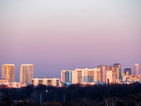 high-rise urban houses over city park at winter sunset in Moscow cityの写真素材