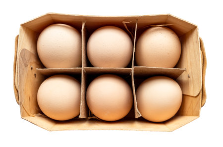 top view of six country brown chicken eggs in plywood box cutout on white backgroundの写真素材
