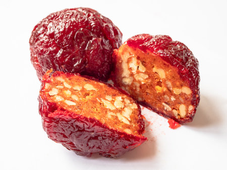 red Alani Armenian sweet with nuts, made from dried plums with addition of honey, on white plate close upの写真素材