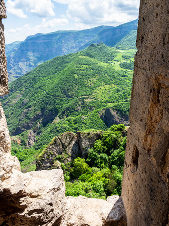 view of green mountains from wall of Tatev Monastery in Syunik Province of Armenia on sunny May morningの写真素材
