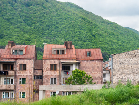 residential houses and green mountain slope in Goris town in Syunik Province of Armenia on overcast May dayの写真素材
