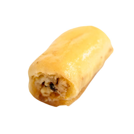 piece of baklava roll with nuts cut out on white backgroundの写真素材