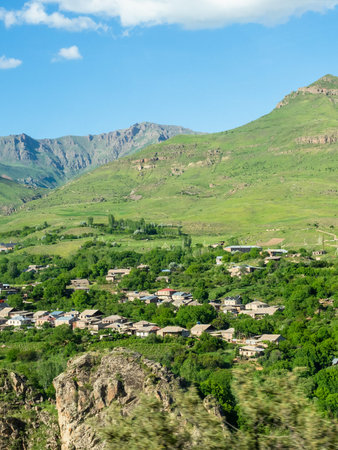 village on green mountain slope in Syunik province of Armenia on sunny May day