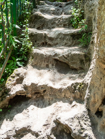 old travertine steps to Vorotan River from Devil's Bridge in mountain gorge, between villages of Tatev and Halidzor in Syunik Province of Armenia on sunny May dayの写真素材