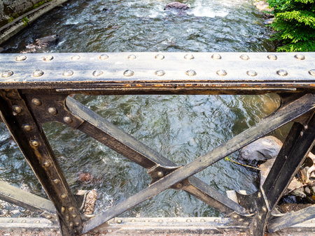 old bridge steel railing accross Borjomula River in Central park in Borjomi resort town, Georgia on sunny summer dayの写真素材