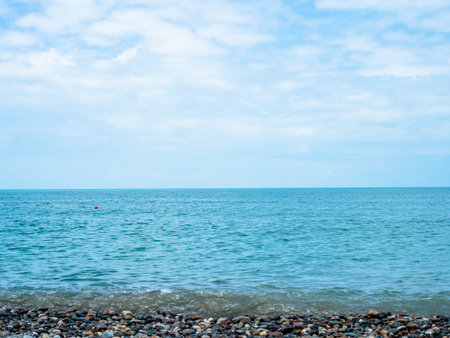 view of Black Sea water from pebble beach in Batumi city, Georgia on sunny summer dayの写真素材