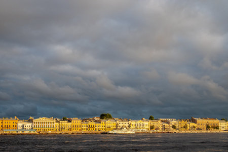 cloudy sky over English Embankment of Great Neva river in Saint Petersburg city, Russia lit by setting sun in sunny summer eveningの写真素材
