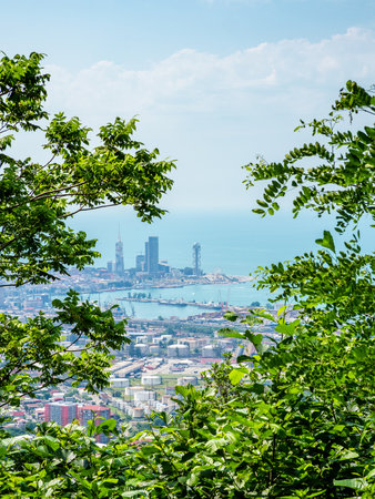 above view of port and Batumi city on coast od Black Sea from Tsminda Sameba Monastery on Mount Sameba on hot sunny summer day, Georgiaの写真素材