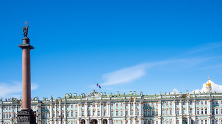 Alexander Column and Winter Palace with state Russian flag in Saint Petersburg city on sunny summer dayの写真素材