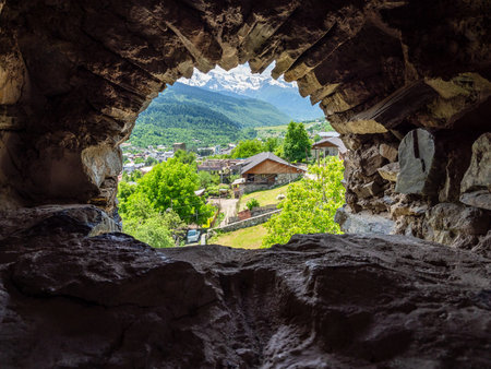 above view of small street in Mestia townlet from arch window in svan tower in Samegrelo-Zemo Svaneti province of Georgia in sunny summer dayの写真素材
