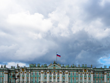 cloudy sky over Winter Palace with State Russian flag on Palace square in St Petersburg city on summer dayの写真素材