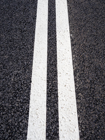 above view of freshly painted double solid lines on new asphalt surface of expresswayの写真素材