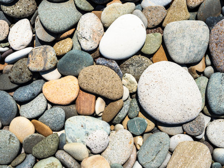 natural tumbled pebbles on beach of Black Sea in Batumi city, Georgia on sunny summer dayの写真素材