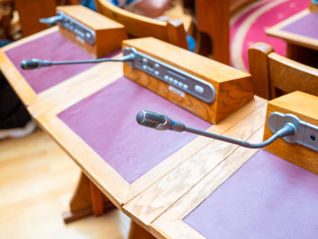 microphones at desks at working places in meeting room